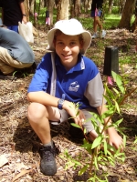 Ben waiting to water his newly planted shrub